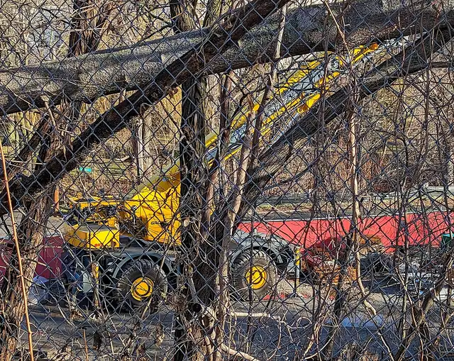Yellow rough-terrain crane parked on a work site